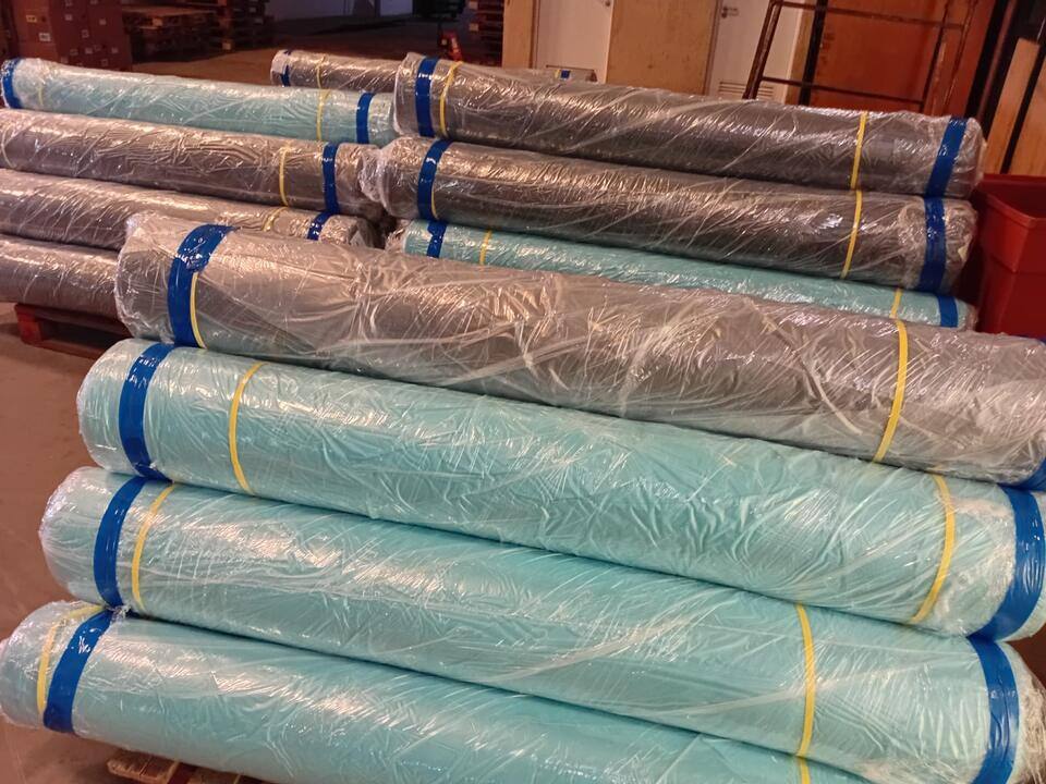 Close view of rolls wrapped in film and banded with tape